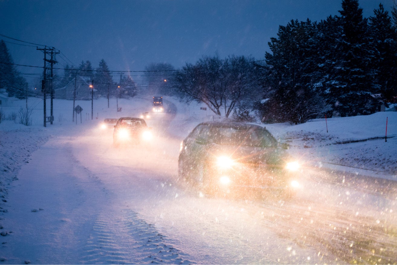 Blizzard on the road dura=ing a cold winter evening