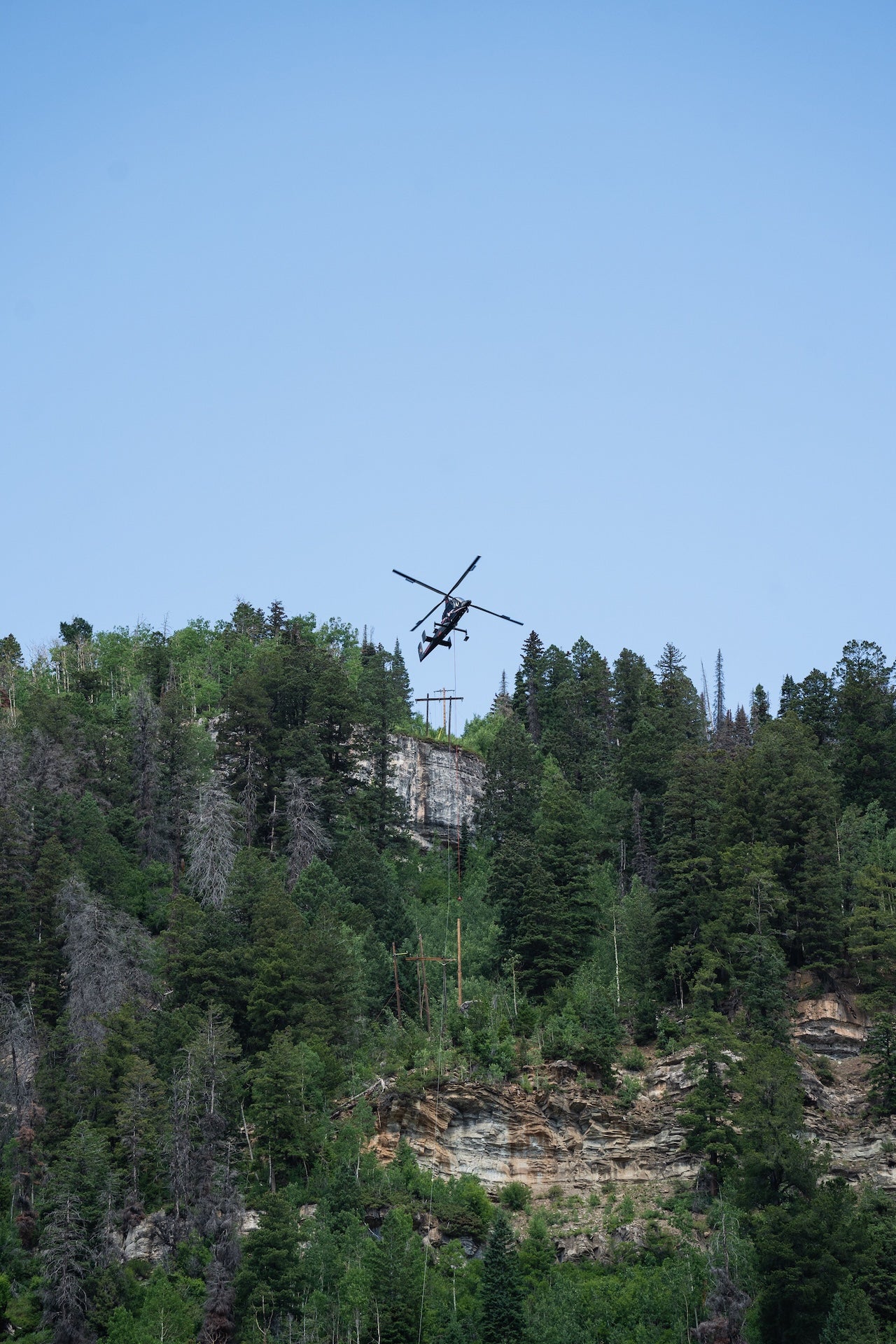A Helicopter carrying a power pole