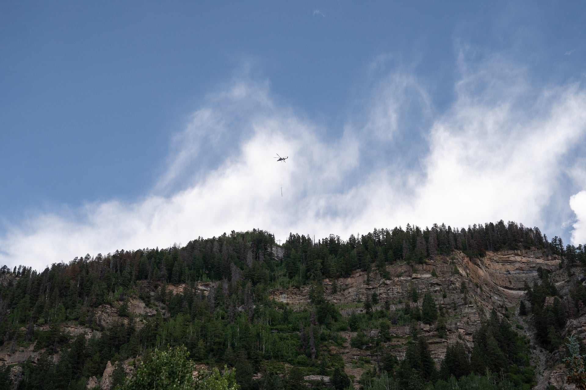 A Helicopter carrying a power pole