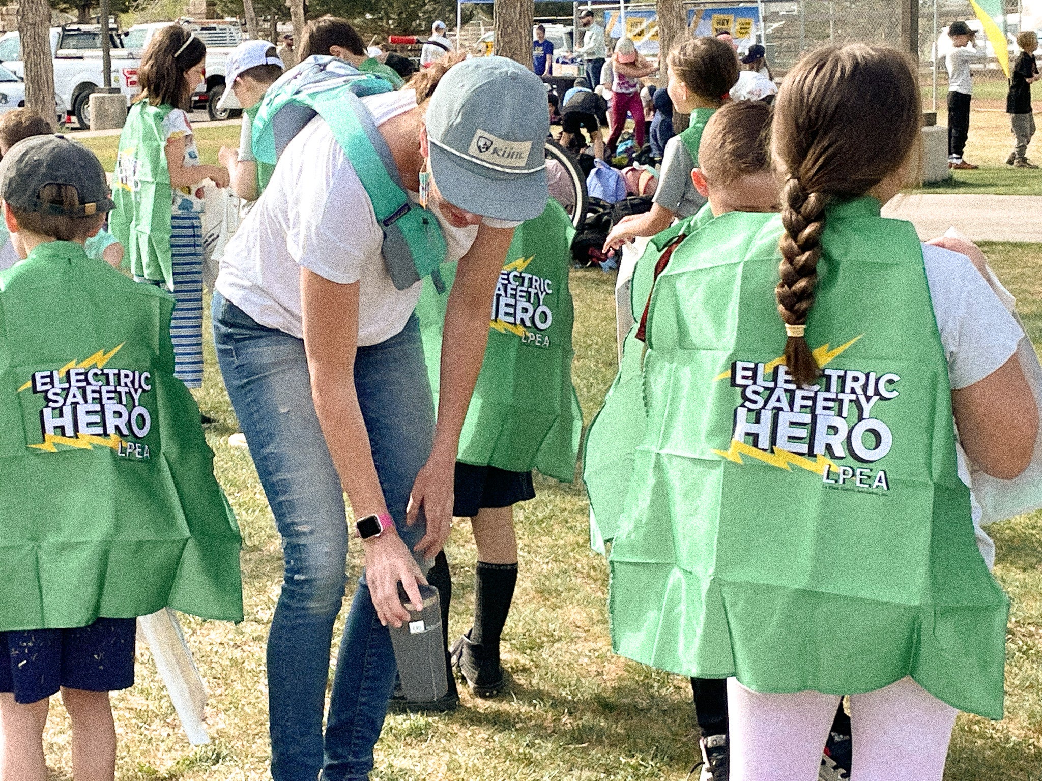 Kids wearing green safety hero capes
