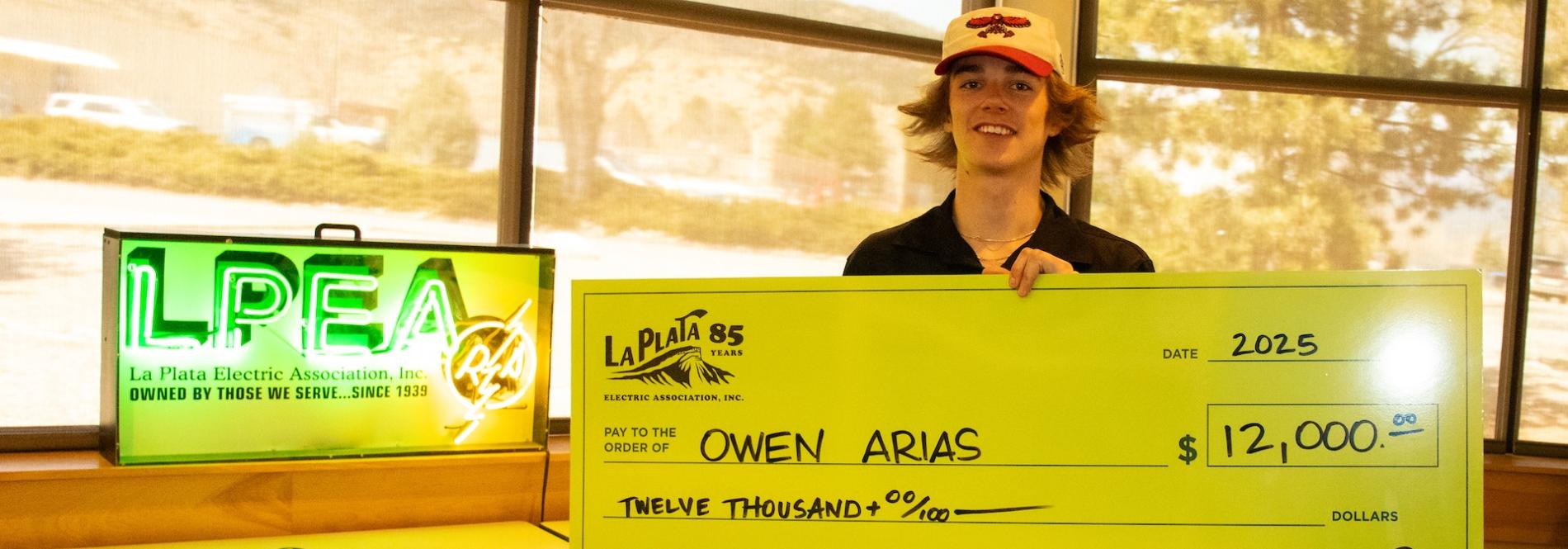 Student poses with scholarship check