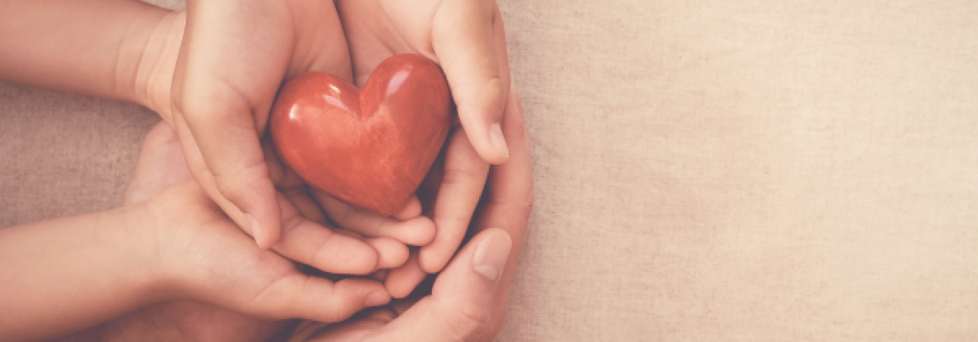 hands holding a glass heart