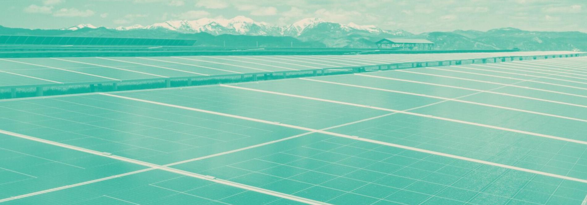 Solar panels with mountains in the background