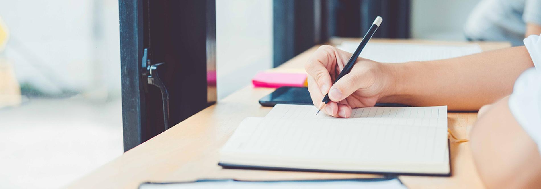 Student writing in a notebook