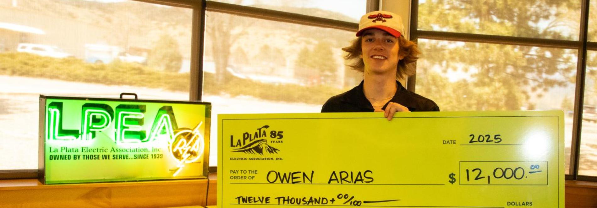 student with a giant check