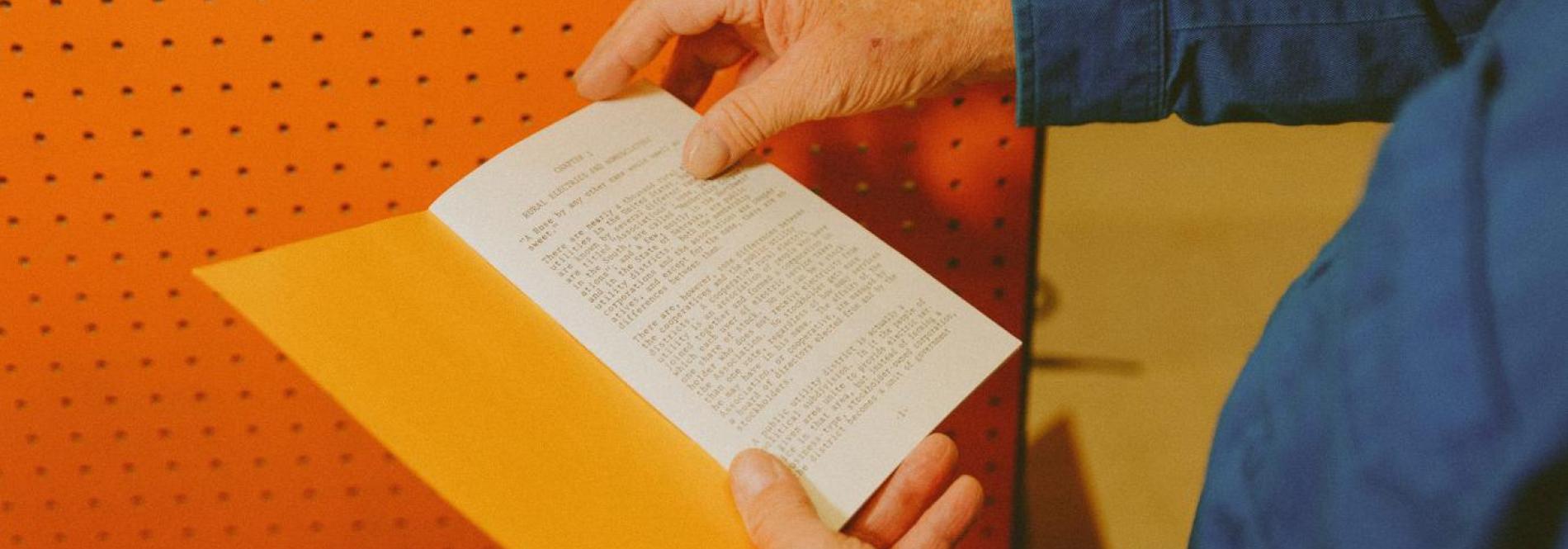 Hand flipping through a booklet