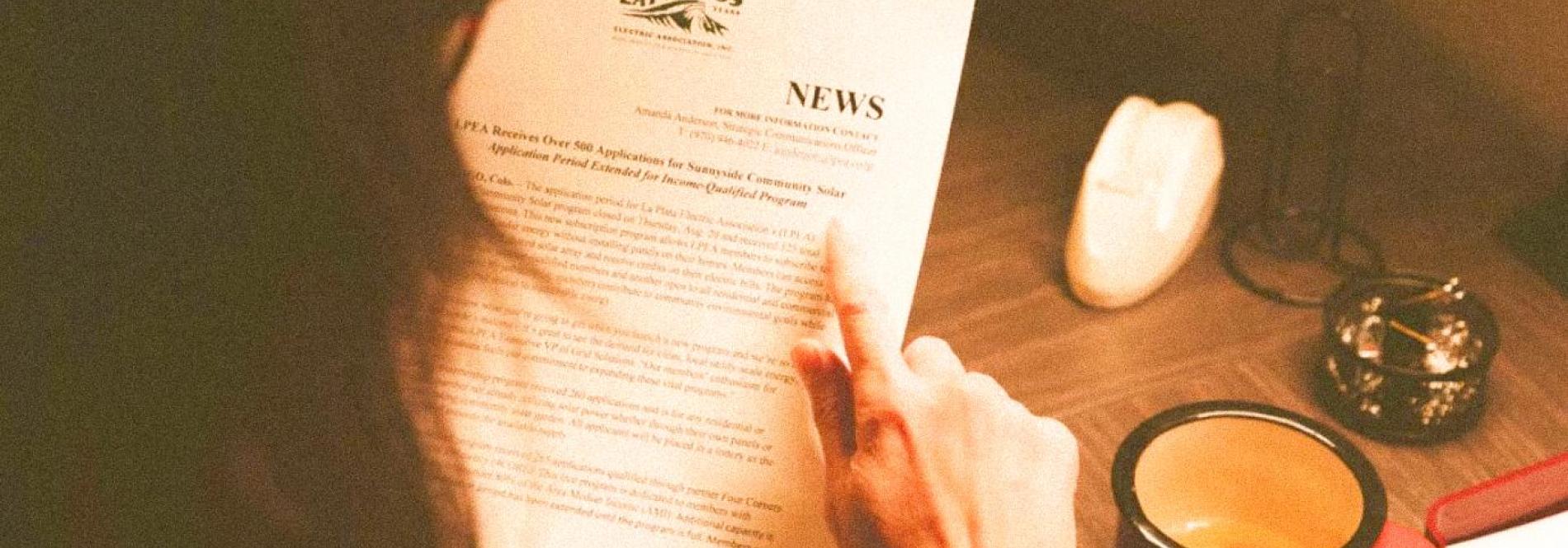a woman reading a news brief 